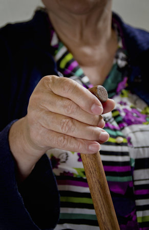 old woman with stickの写真素材