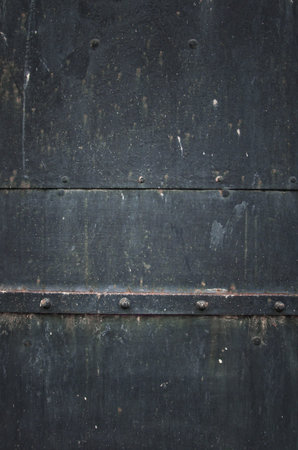 Old metal door detail. Rusty metal texture with metal screws.の写真素材