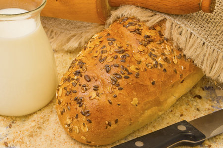 Bread and milk in a jug with rolling pin.