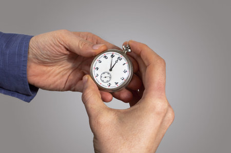 Old pocket watch in hand. Time pass concept.