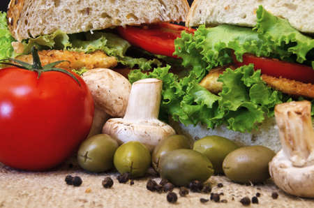 Fresh vegetables with sandwiches in backgroundの写真素材