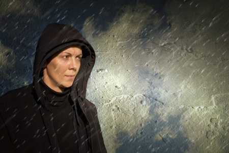 Portrait of serious person in the rain. Weather concept.