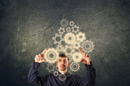 Businessman touching gear elements. Mechanism concept.