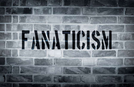Fanaticism stencil print on the grunge white brick wallの写真素材