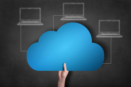 Businessman is holding a blue cloud icon on blackboard