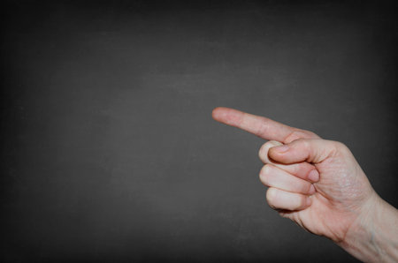 Finger point at the blank blackboard