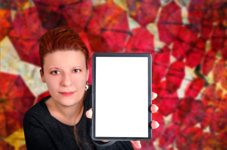 Young woman showing a blank digital tablet. Shalow depth of field. Weather forecast and technology concept.の写真素材