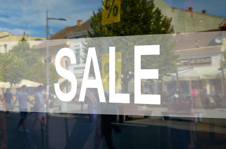 Retail image of a sale sign in a clothing store window (with shallow DoF)の写真素材