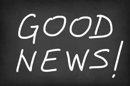"Good News!" handwritten with white chalk on a blackboardの写真素材
