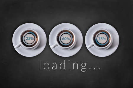 Loading word on blackboard with coffee cupの写真素材