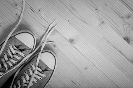 Sneakers on wooden background. Black and white image.の写真素材