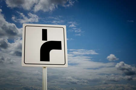 Road sign with cloudy sky background. Main road bends to the right.の写真素材