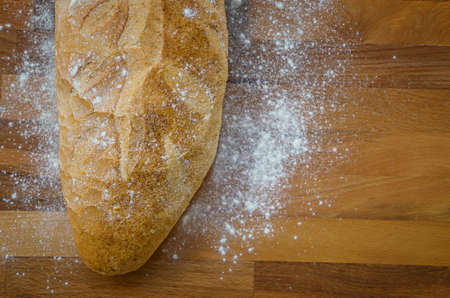 Rustic bread on old vintage planked wood table.の写真素材