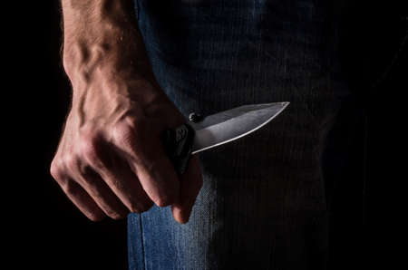 The man with a knife in a hand. Closeup.の写真素材