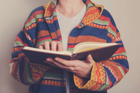 Young man reading a book. Toned image.の写真素材