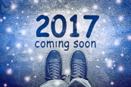 Sneakers from above standing on 2017 coming soon signの写真素材