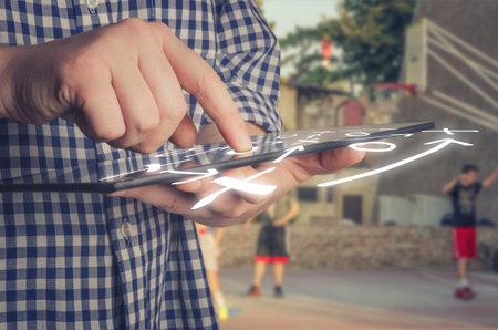 Basketball coach using a digital tablet on the basketball court. Game Plan Tactics Conceptの写真素材