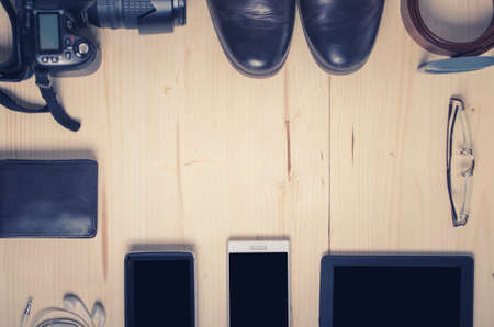Overhead of essentials modern man on wooden background with copy spaceの写真素材