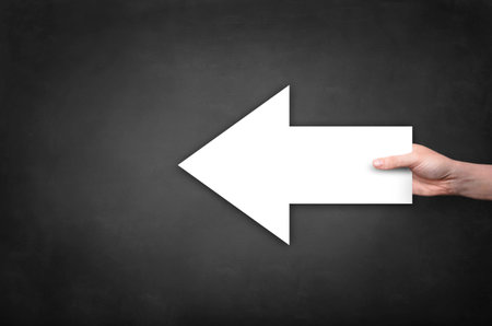 Man hand with white arrow close upの写真素材