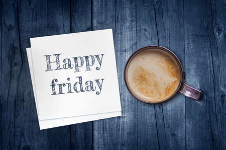 Happy Friday on paper note with coffee cup, top view.の写真素材