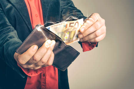 Man gets fifty euro banknote from the wallet. Lightning illustration.の写真素材