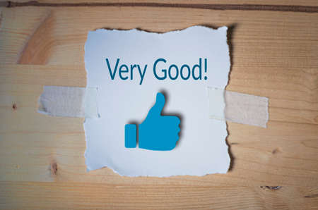 Very good job with thumb up icon on torn note paperの写真素材
