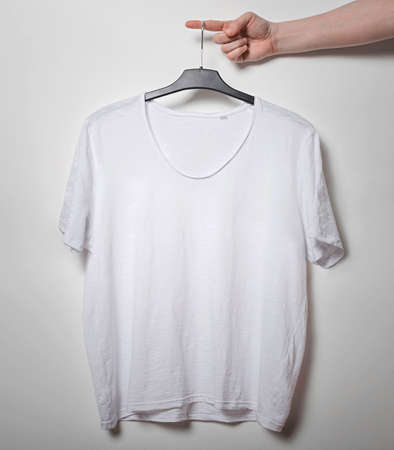 Hand with blank t-shirt on white background. Template for design presentations. Branding Mock-Up.の写真素材