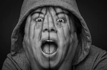 Surreal portrait of a desperate woman covering her face and eyes with her hands. Depression and frustration concept. Double exposure. Black and White.の写真素材