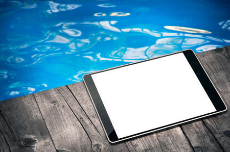 Tablet computer by the poolの写真素材