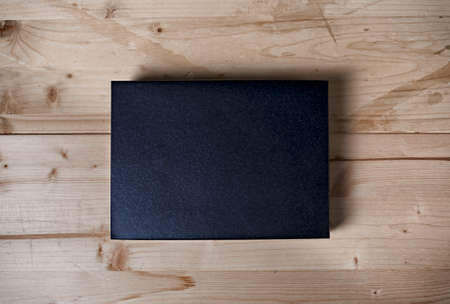 Paper black box mock up on wooden backgroundの写真素材