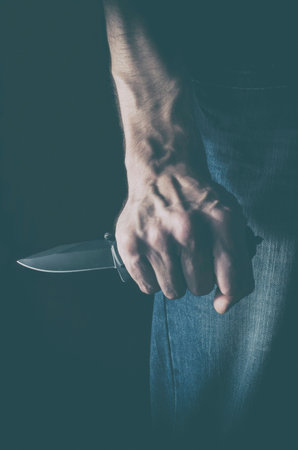 The man with a knife in a hand. Concept of crime, violence and terrorism.の写真素材