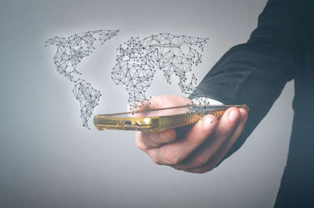 Hand holds mobile smart phone, worldwide connection and social network concept. Smart business concept.の写真素材
