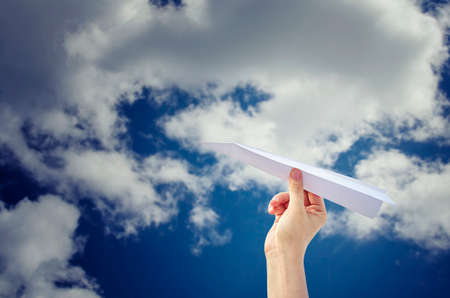 Hand with paper airplane for fly to the sky with dream lifestyle. Freedom concept.の写真素材