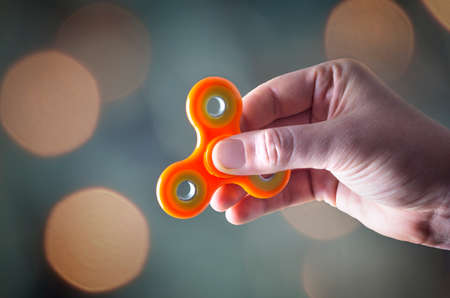 Fidget Spinner. Popular gadget for helping people who have trouble with focusing or fidgeting by relieving nervous energy or psychological stress.の写真素材