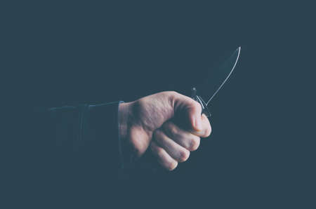 Hand with a knife. Concept of violence, crime and terrorism. Low key image.の写真素材