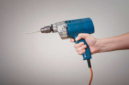 A man's hand with an electric power drill. Mechanic Service Maintenance Conceptの写真素材