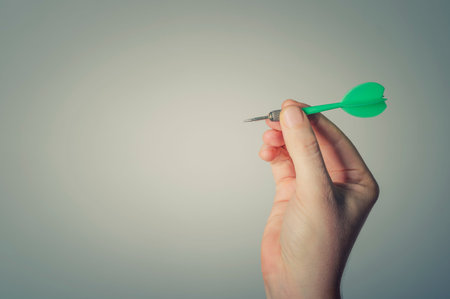 Hand Getting Ready to Throw a Plastic Tip Dartの写真素材