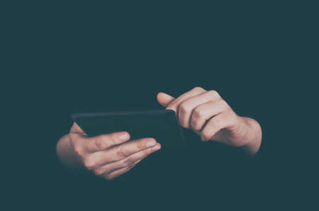 Female hands with tablet PC low key imageの写真素材