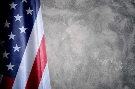 USA flag close up with a concrete wall backgroundの写真素材