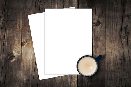 Blank letterhead and coffee cup on vintage wooden table background.の写真素材