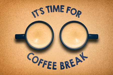 Coffee break concept with two coffee cups on desk, top view.の写真素材