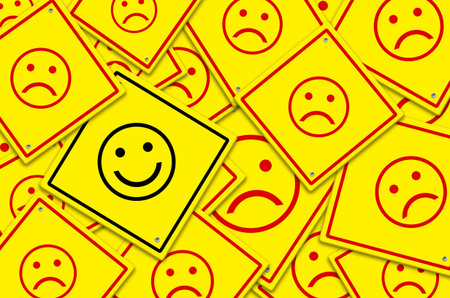 Happy and unhappy concept. Background of yellow road signs. Happy road sign is among sad road signs.の写真素材