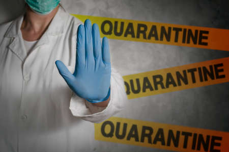 Health worker gesturing stop sign in quarantine.の写真素材