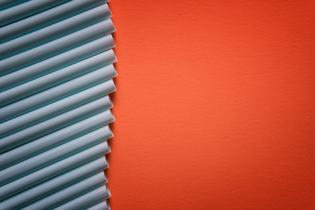 Plastic straws in a row, isolated on orange background. Minimalism concept. Pop art style.