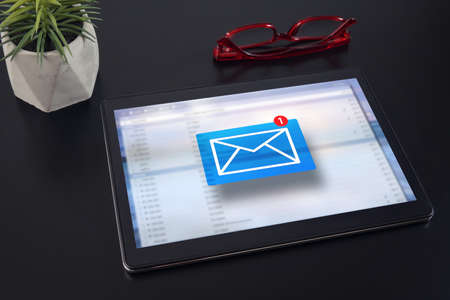 E-mail marketing concept. New email notification on tablet computer.の写真素材