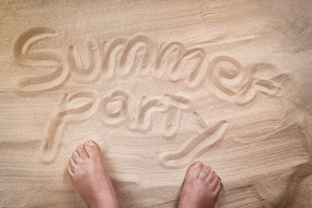 Summer party inscription on sandy beach, personal point of view.の写真素材