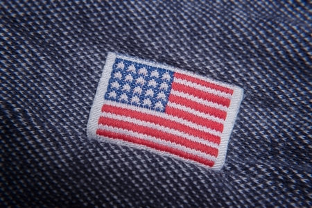 Buy American. USA flag clothing label close up.