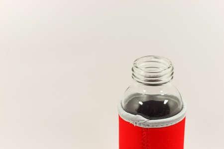 Isolate glass bottle in red cover with spaceの写真素材