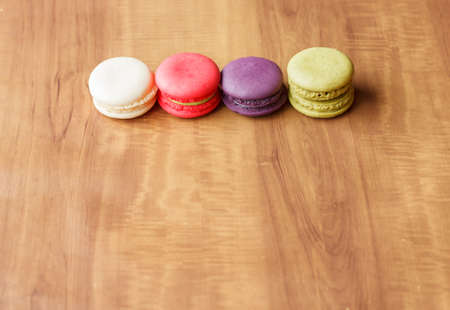 Colorful French Macarons on wooden background.の写真素材