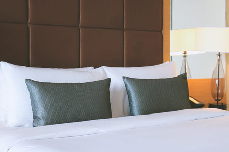 White pillows and grey pillows on bed in the luxury hotel.